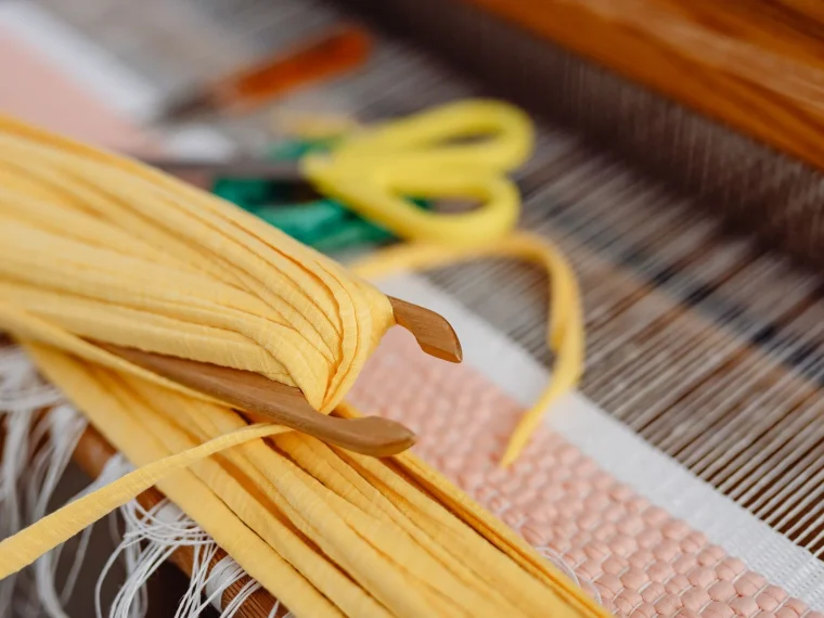 Factory floor with workers, machinery, and large windows, sustainable sourcing strategies for textiles.
