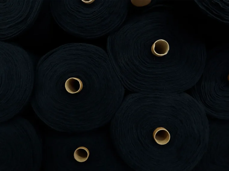 Organic cotton bales in a well-organized warehouse, sustainable sourcing.