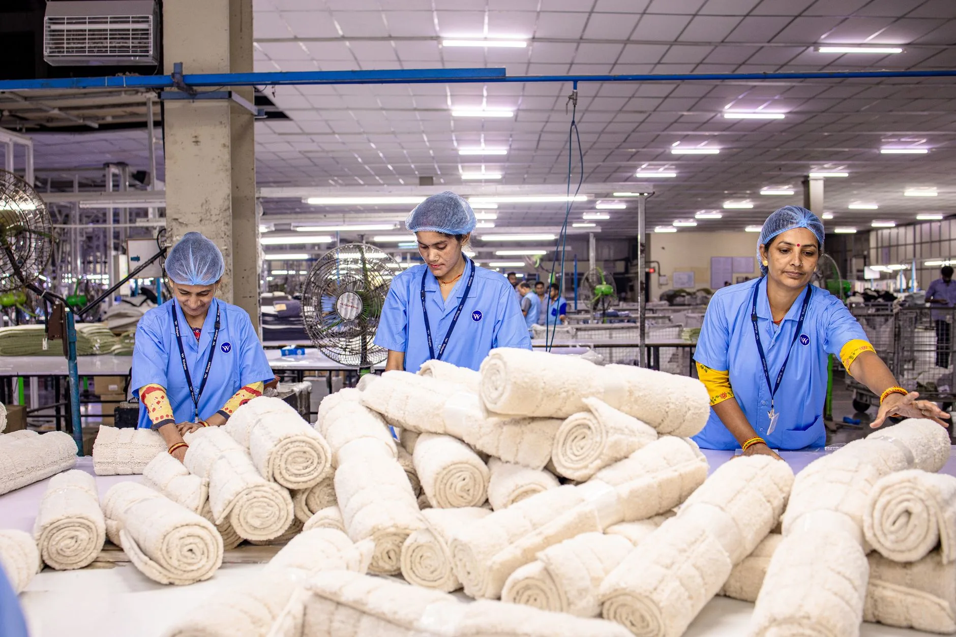 Cotton fleece factory under diffused light, muted colors, midground focus, water and energy efficiency.