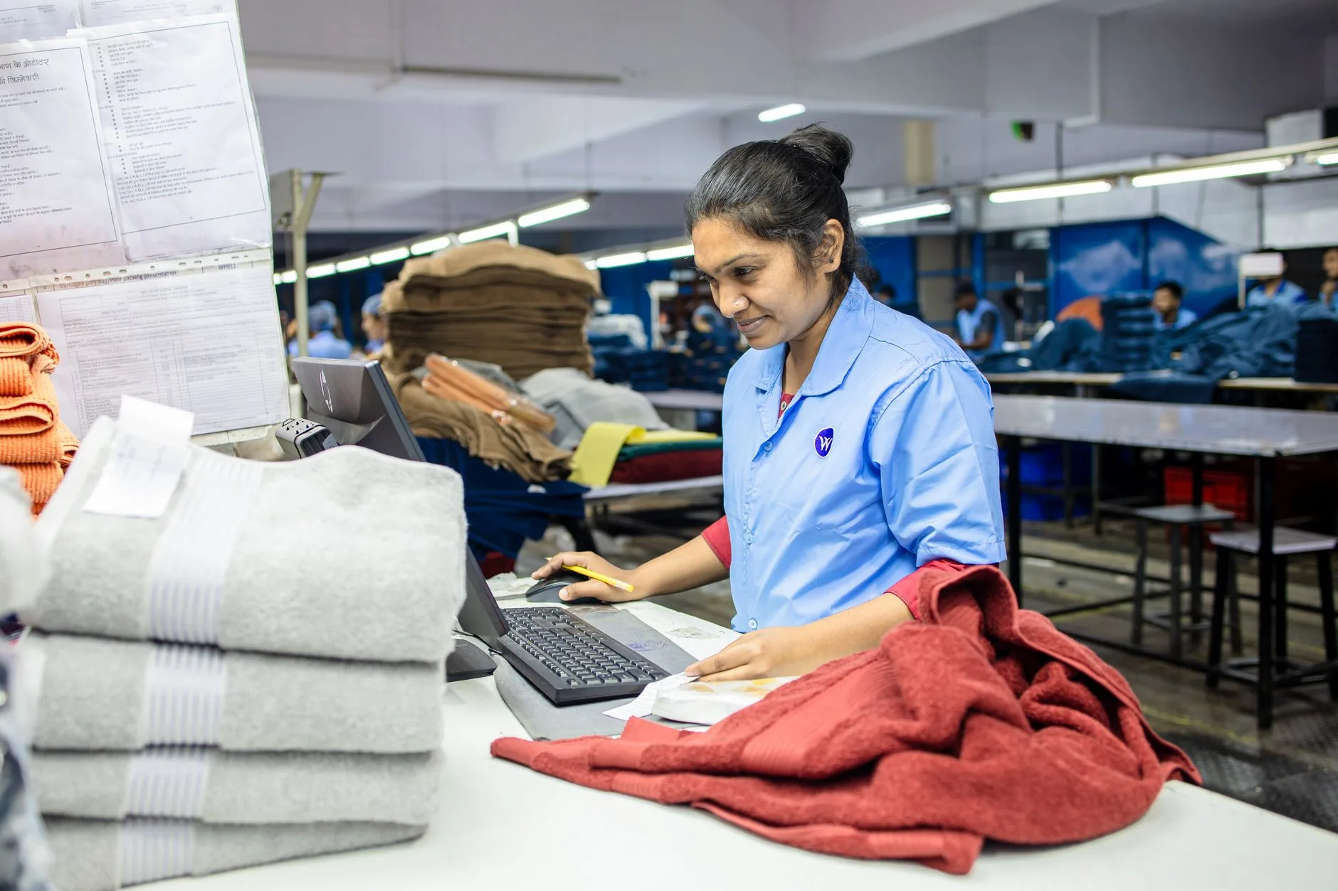 Warehouse filled with neatly folded deadstock fabrics in varied textures and patterns.