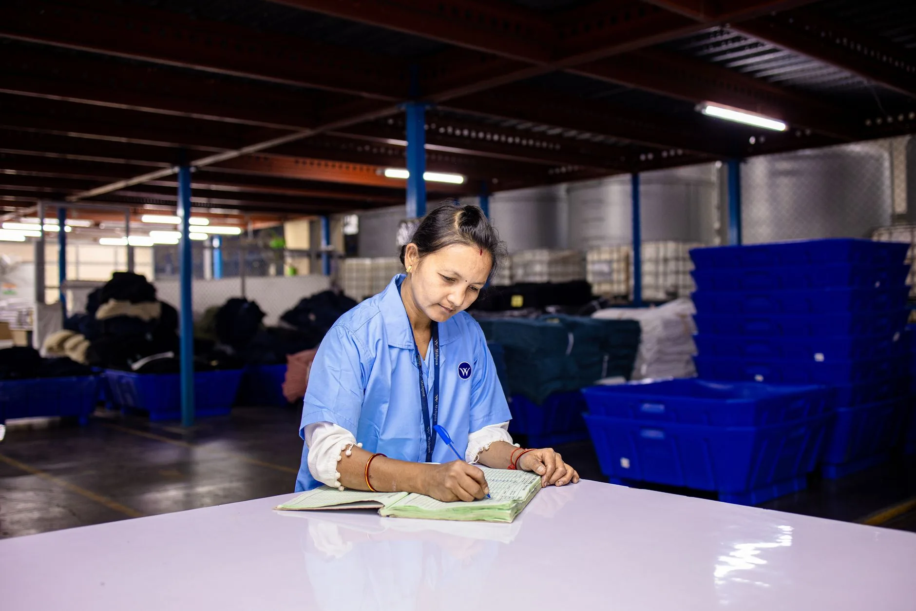 Industrial fabric recycling facility under soft, diffused lighting, muted colors, circular fashion.
