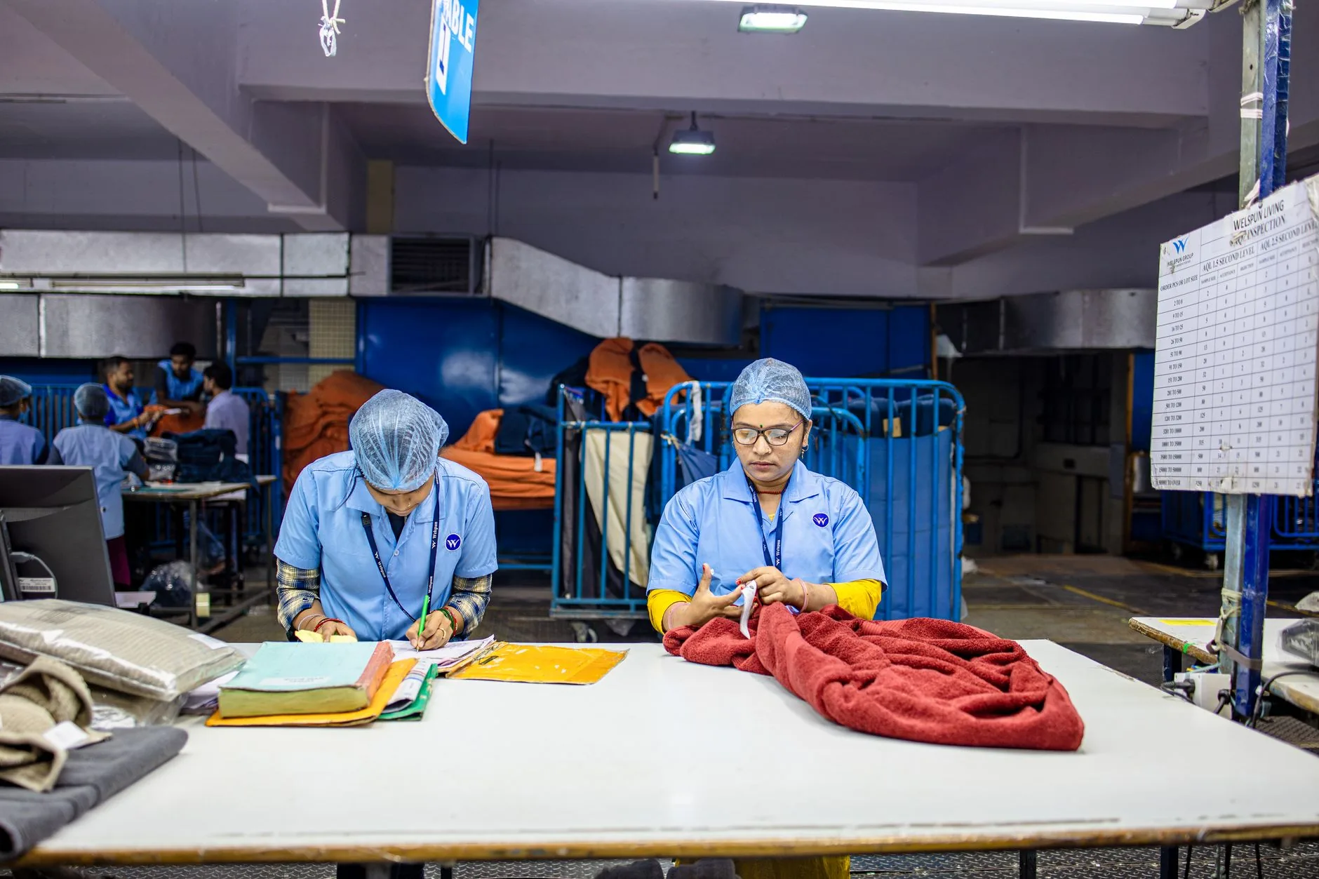 Hand inspecting sustainable fast-drying fabric, soft lighting, muted colors. Topic: Eco-friendly technical fabrics.