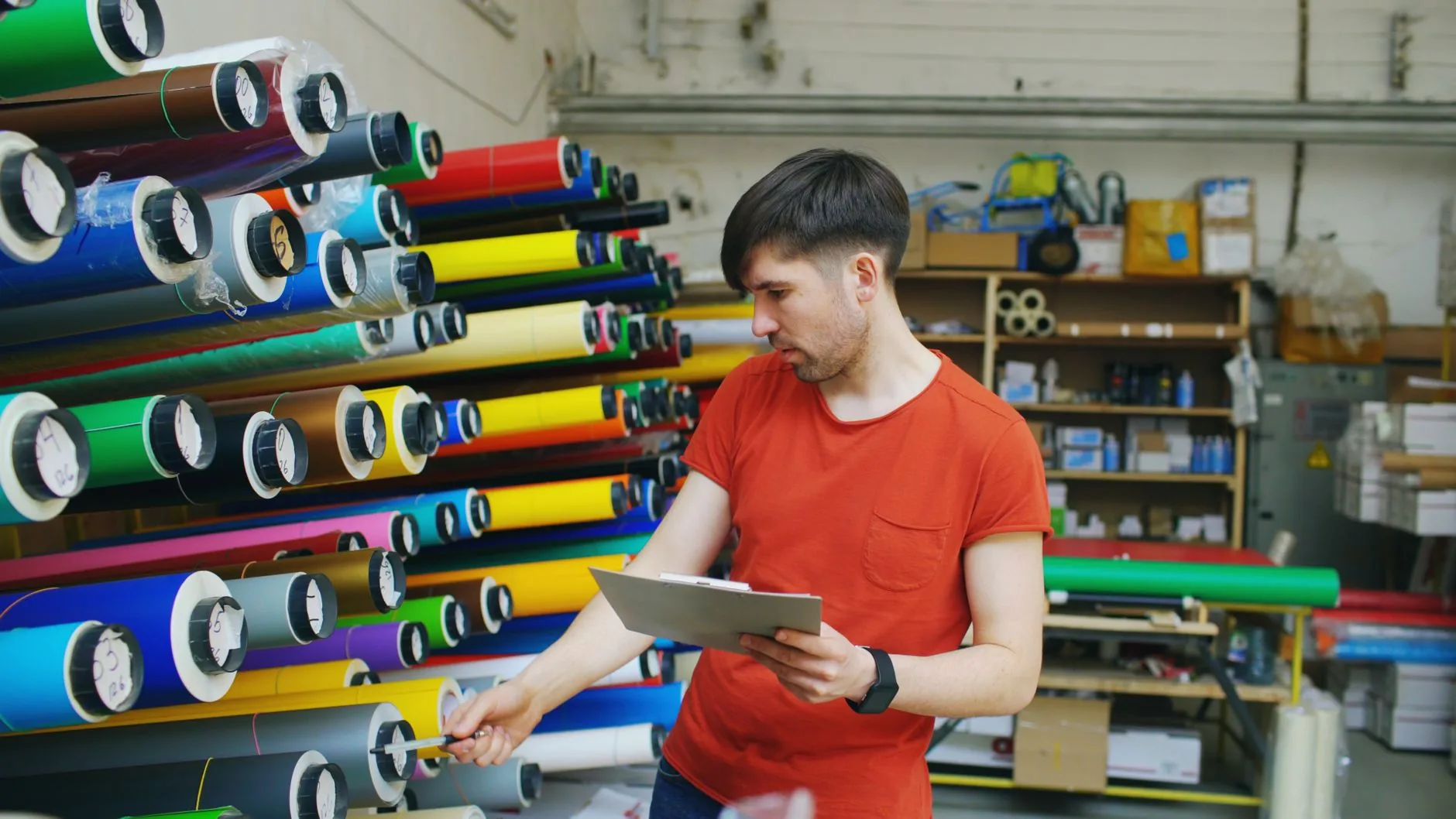 Hand cutting fabric along bolt edge, minimizing waste. Woven fabric material techniques.